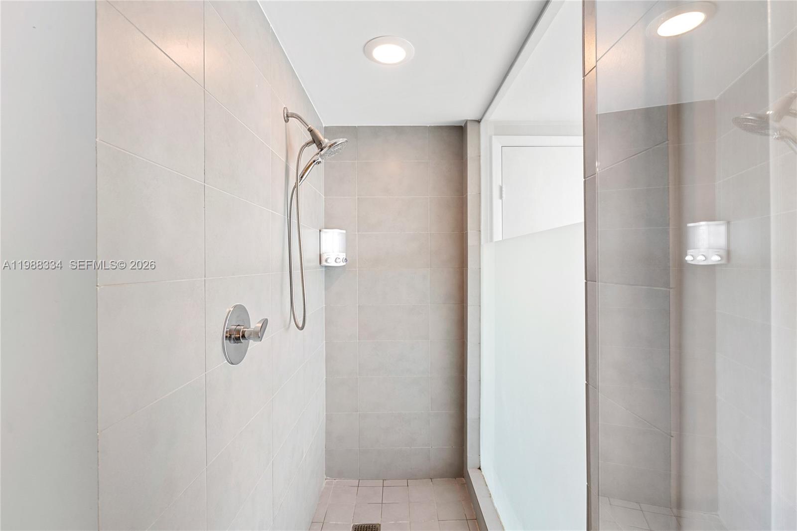 92 Southwest 3rd Street, Unit 4702 Miami, FL 33130 - Photo 47 of 47 a bathroom with a glass shower door