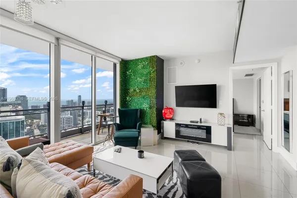 a living room with furniture tv and a large window