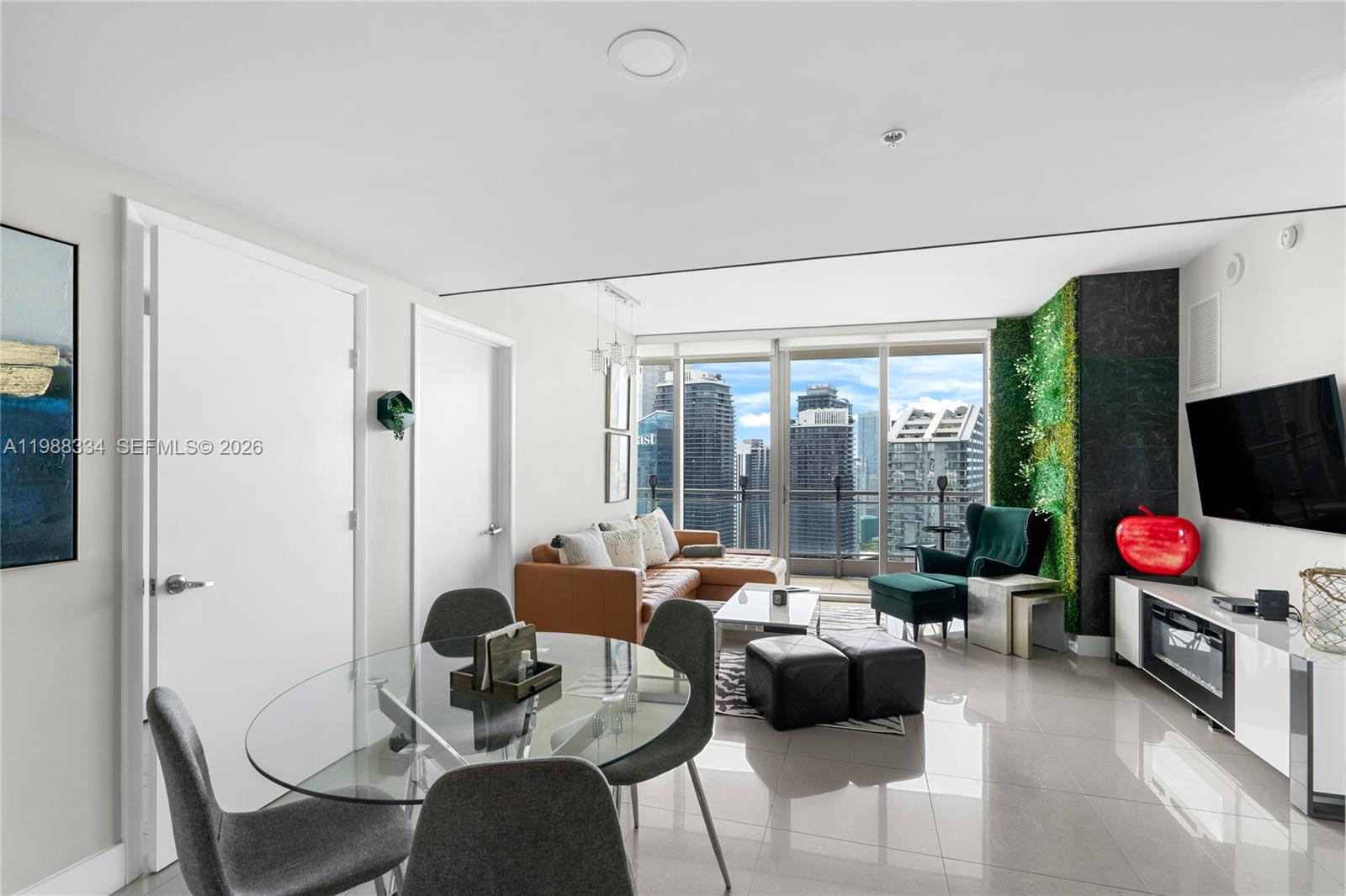 92 Southwest 3rd Street, Unit 4702 Miami, FL 33130 - Photo 8 of 47 a living room with furniture flat screen tv and a large window