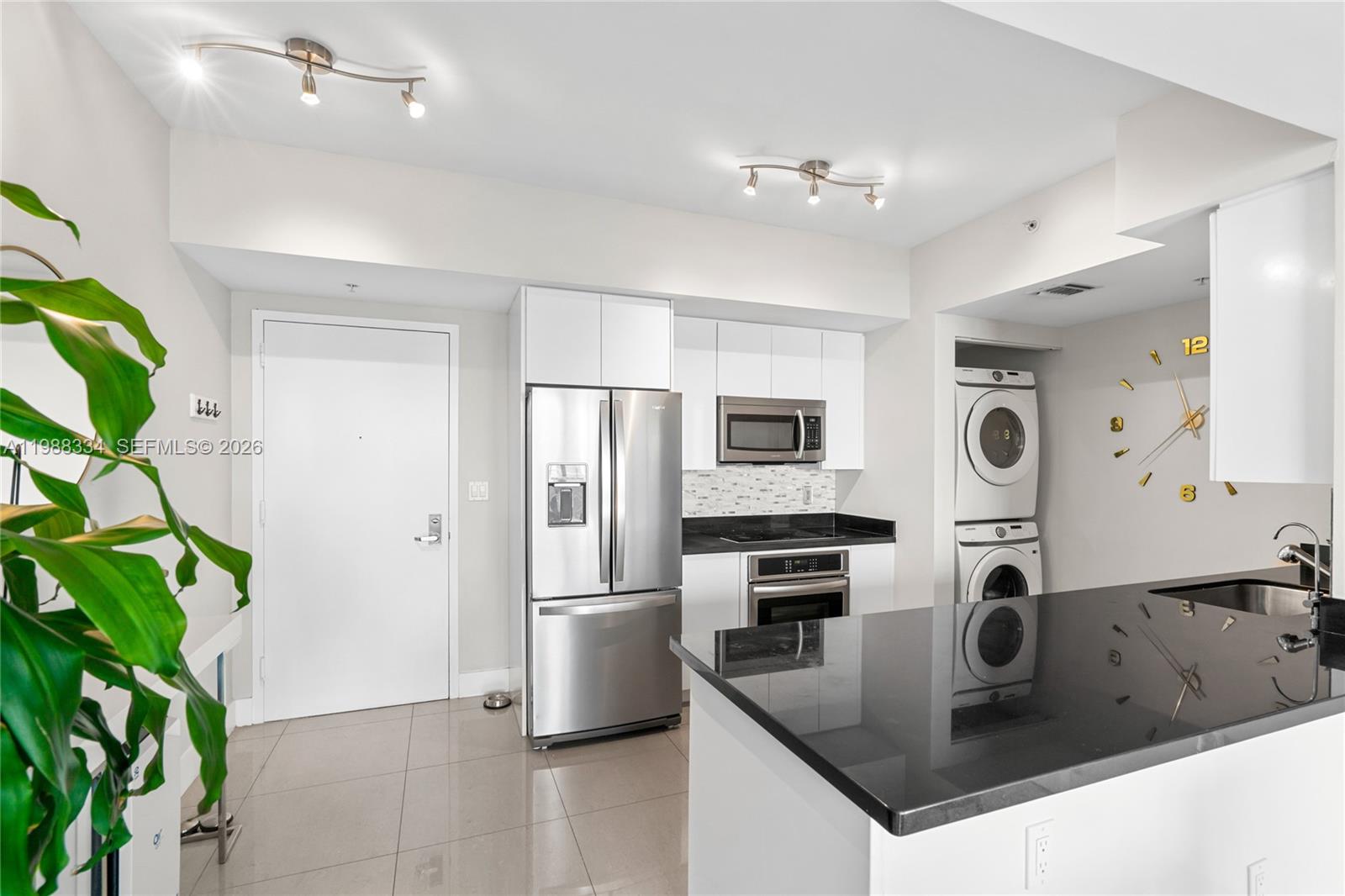 92 Southwest 3rd Street, Unit 4702 Miami, FL 33130 - Photo 10 of 47 a kitchen with stainless steel appliances granite countertop a sink a stove and a refrigerator
