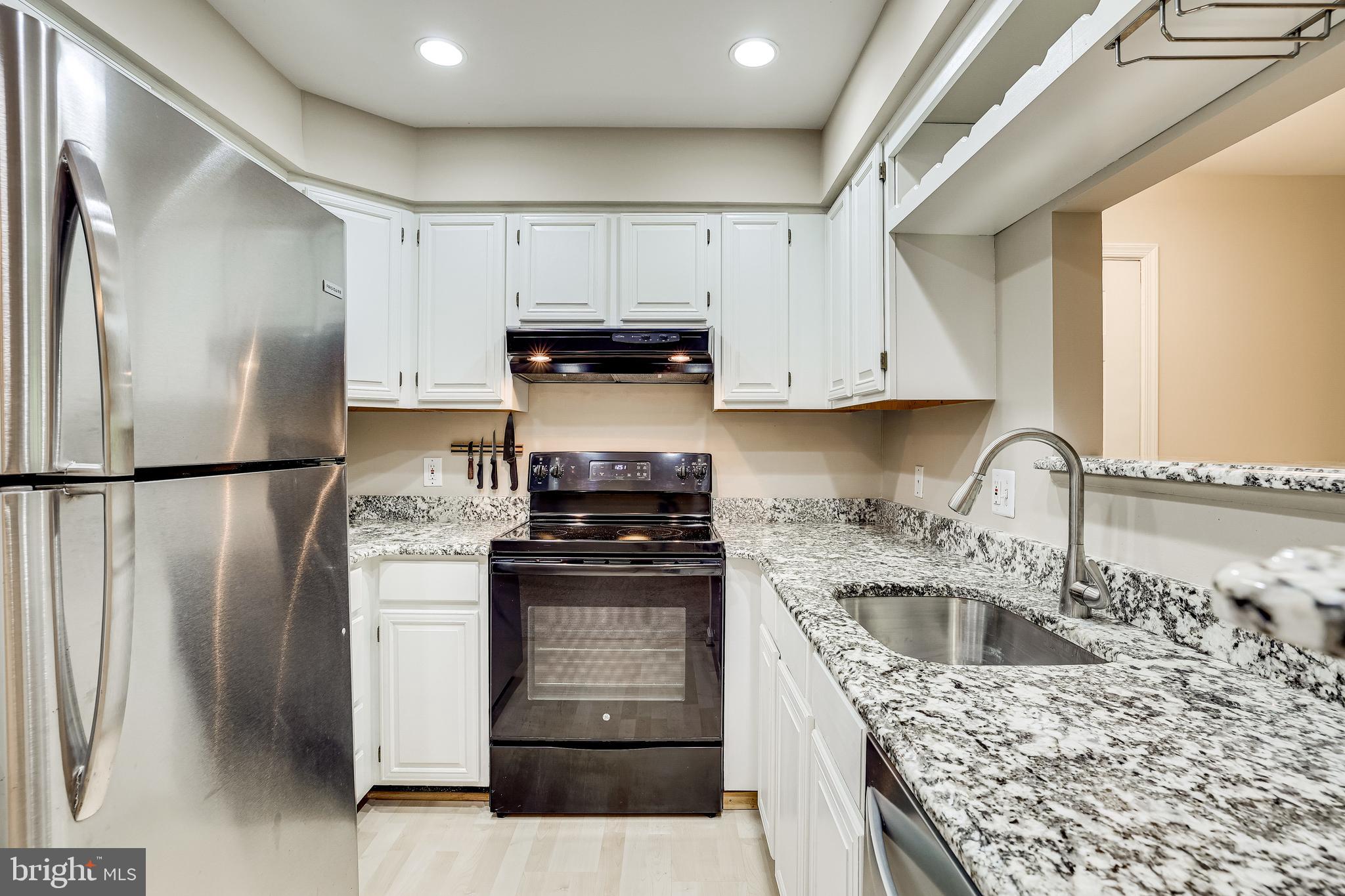 2229 Lovedale Lane, Unit G Reston, VA 20191 - Photo 12 of 38 a kitchen with stainless steel appliances granite countertop a refrigerator sink and stove