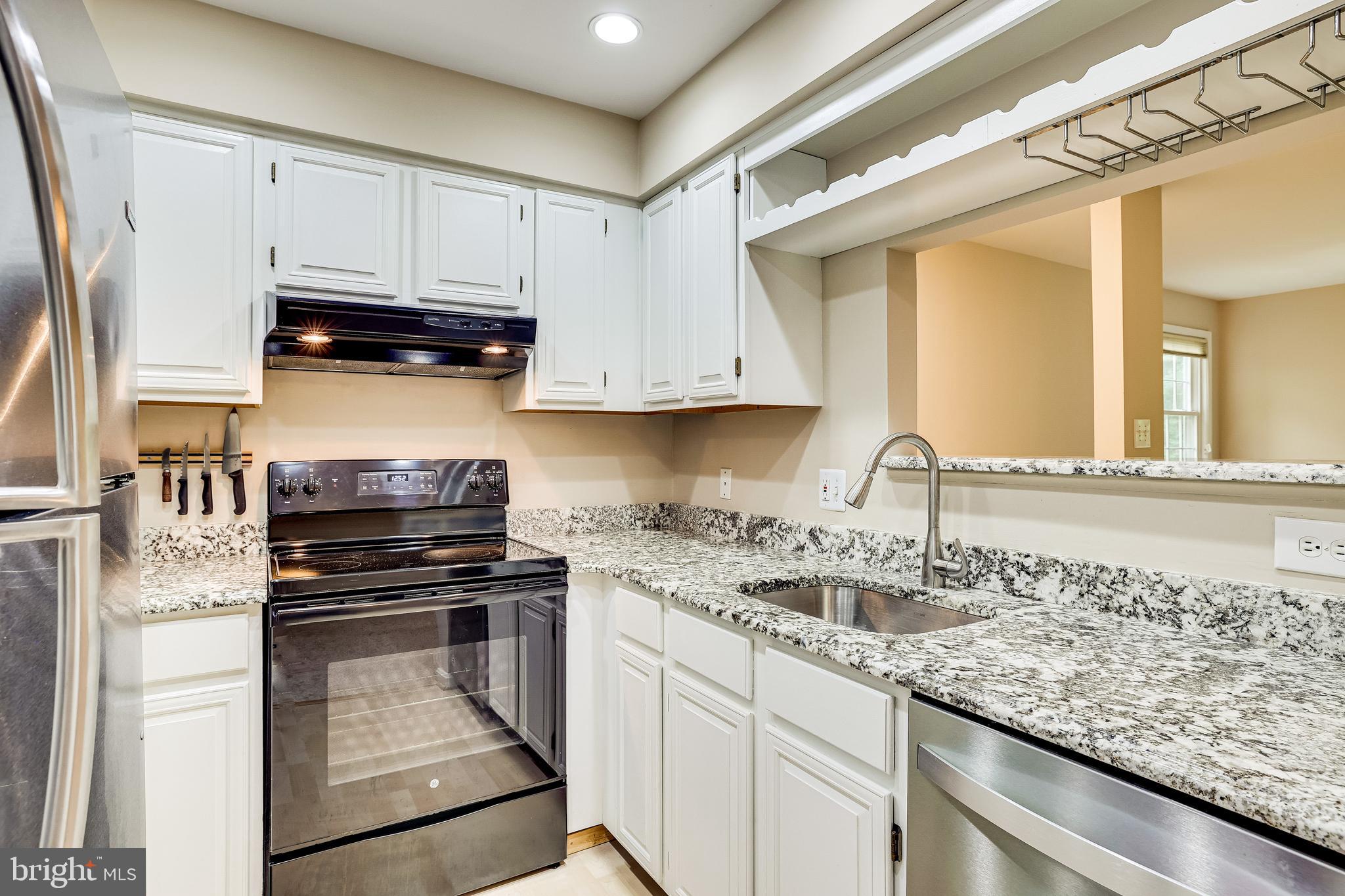 2229 Lovedale Lane, Unit G Reston, VA 20191 - Photo 13 of 38 a kitchen with granite countertop a stove sink and cabinets