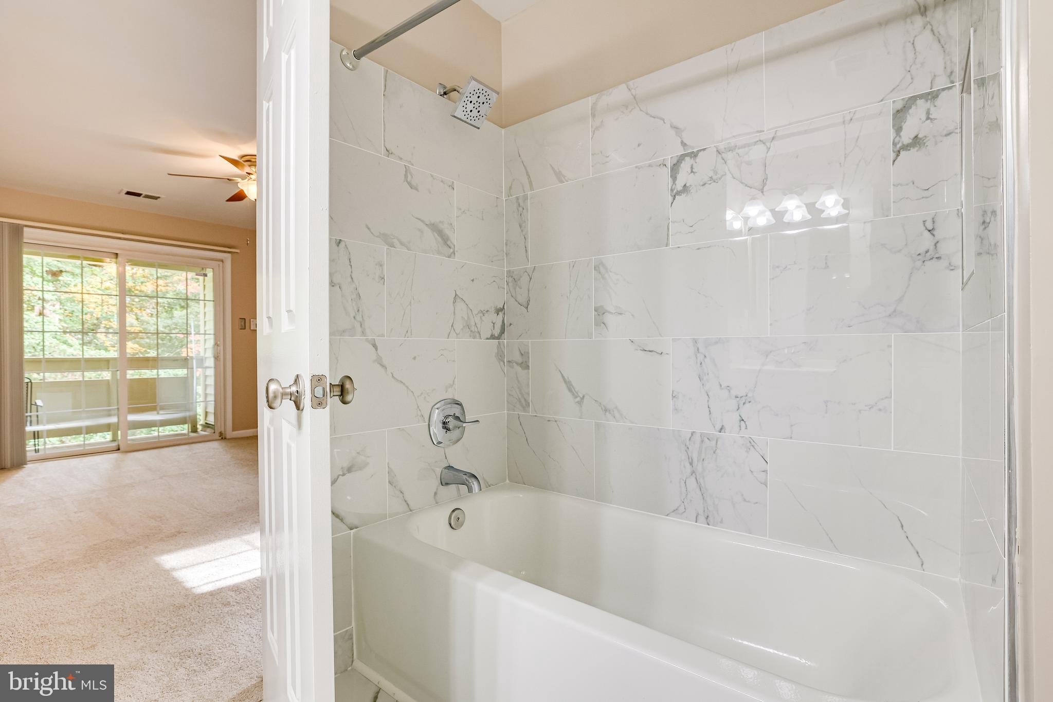 2229 Lovedale Lane, Unit G Reston, VA 20191 - Photo 21 of 38 a bathroom with a bathtub and a shower