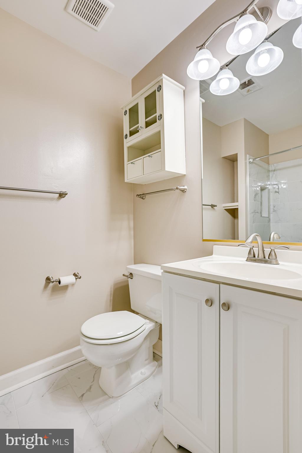 2229 Lovedale Lane, Unit G Reston, VA 20191 - Photo 22 of 38 a bathroom with a sink a toilet and a mirror
