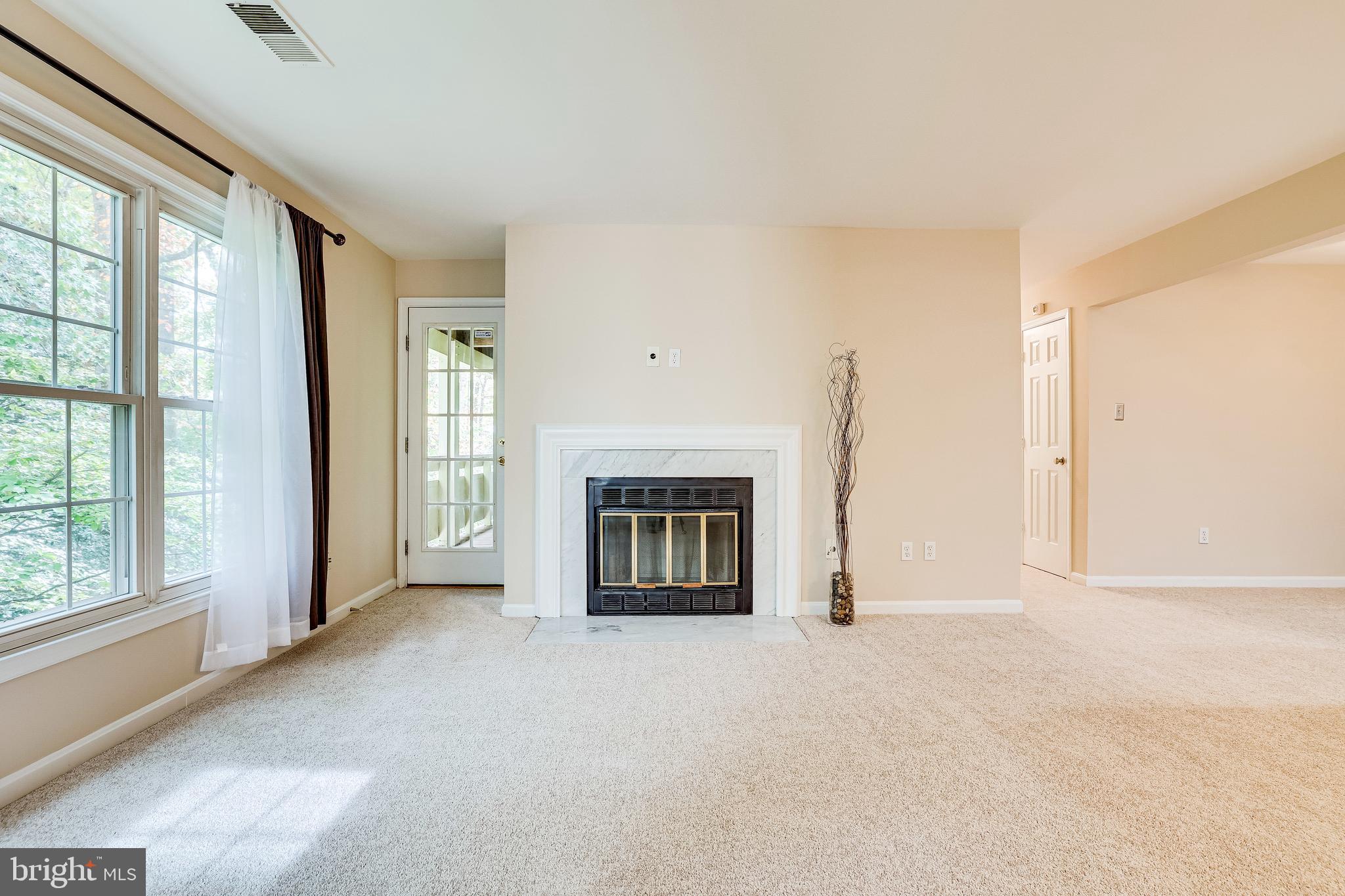 2229 Lovedale Lane, Unit G Reston, VA 20191 - Photo 7 of 38 a view of an empty room with a fireplace and a window