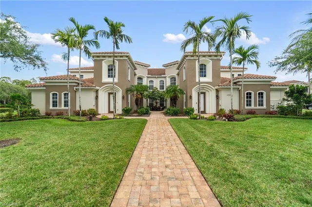 a front view of a house with a garden and plants