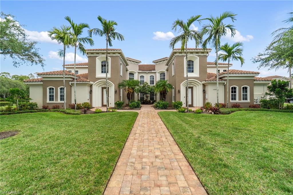 a front view of a house with a garden and plants