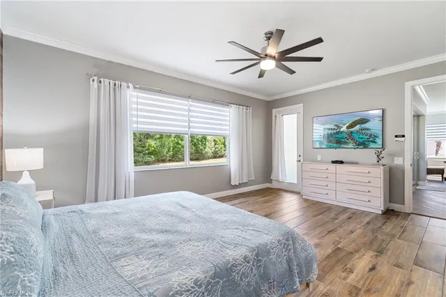 a bedroom with a large bed and a large window