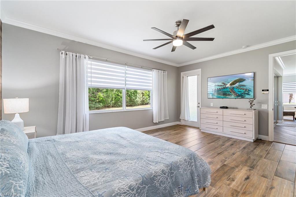 11000 Carrara Court, Unit 102 Bonita Springs, FL 34135 - Photo 14 of 31 a bedroom with a large bed and a large window