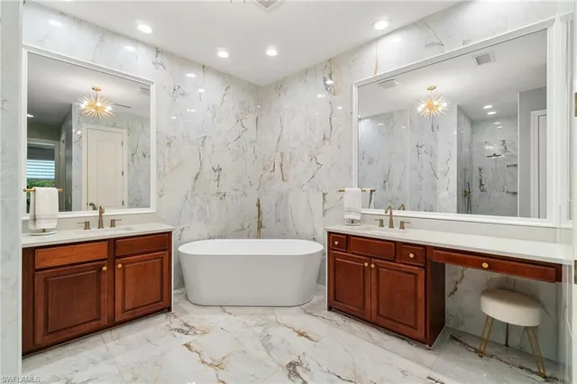 a bathroom with a double vanity sink mirror double and bathtub