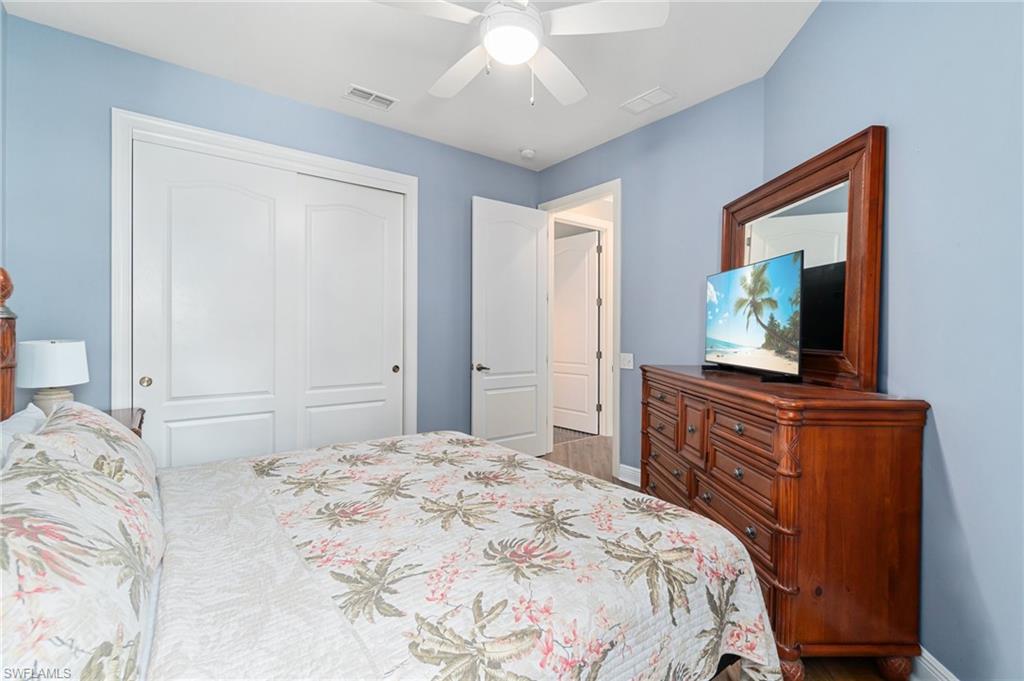 11000 Carrara Court, Unit 102 Bonita Springs, FL 34135 - Photo 19 of 31 a bedroom with a bed and a flat screen tv