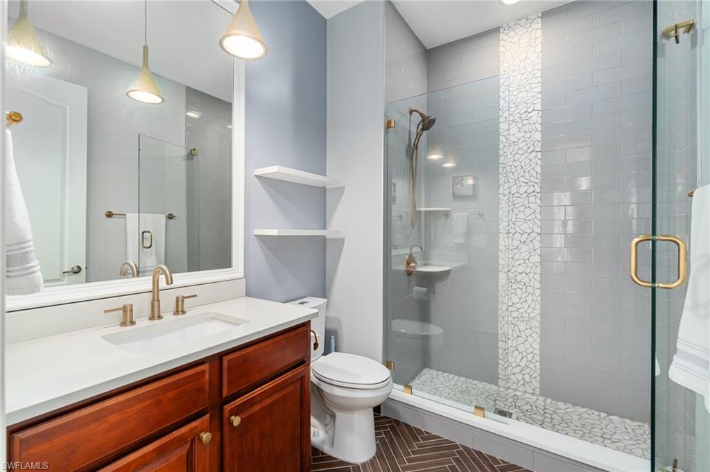 11000 Carrara Court, Unit 102 Bonita Springs, FL 34135 - Photo 20 of 31 a bathroom with a sink a toilet and shower