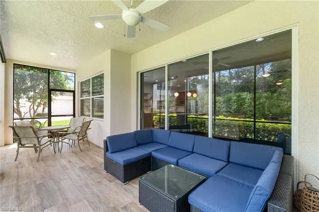 a living room with furniture and a floor to ceiling window