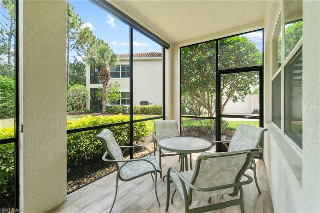 11000 Carrara Court, Unit 102 Bonita Springs, FL 34135 - Photo 28 of 31 a view of an outdoor dining space with furniture and garden