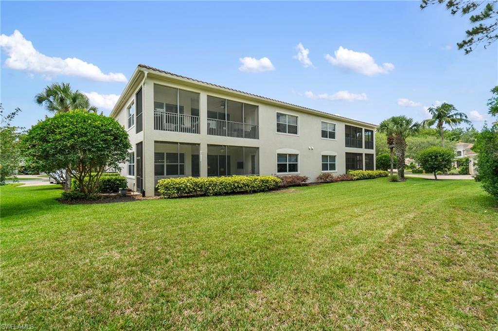11000 Carrara Court, Unit 102 Bonita Springs, FL 34135 - Photo 29 of 31 front view of a house with a yard