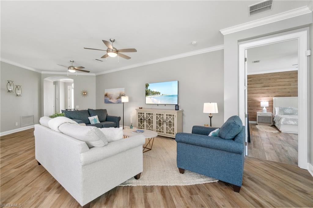 11000 Carrara Court, Unit 102 Bonita Springs, FL 34135 - Photo 5 of 31 a living room with furniture and wooden floor