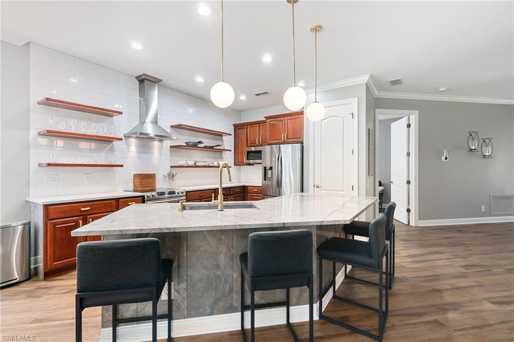 11000 Carrara Court, Unit 102 Bonita Springs, FL 34135 - Photo 10 of 31 a large kitchen with a table and chairs
