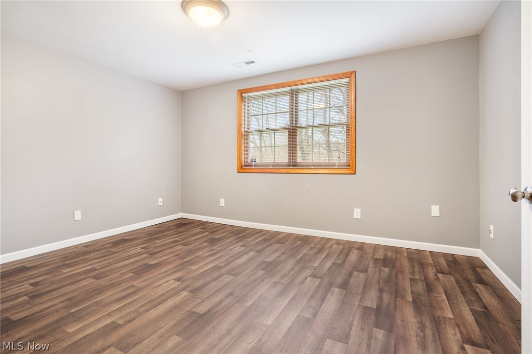 2414 Charing Cross Road Northwest Canton, OH 44708 - Photo 23 of 36 Lower-level bedroom featuring dark hardwood / wood-style floors