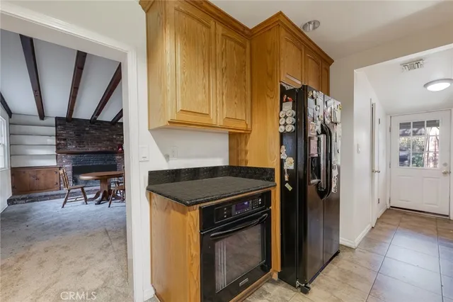 a kitchen with a refrigerator and a stove top oven