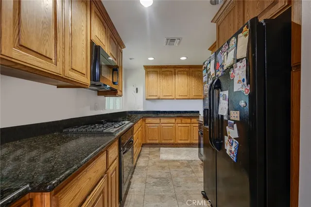 a kitchen with stainless steel appliances granite countertop a stove and a refrigerator