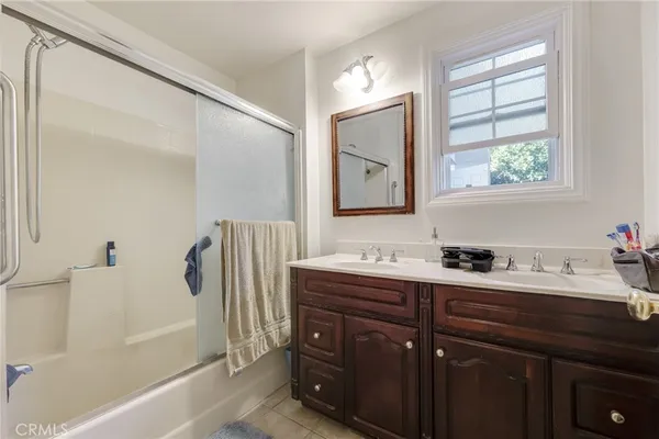 a bathroom with a tub sink and mirror