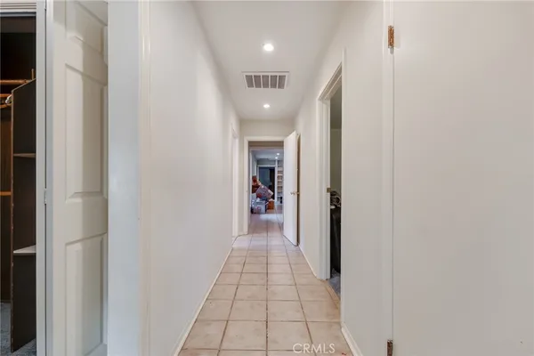 a view of a hallway with wooden floor and a hallway