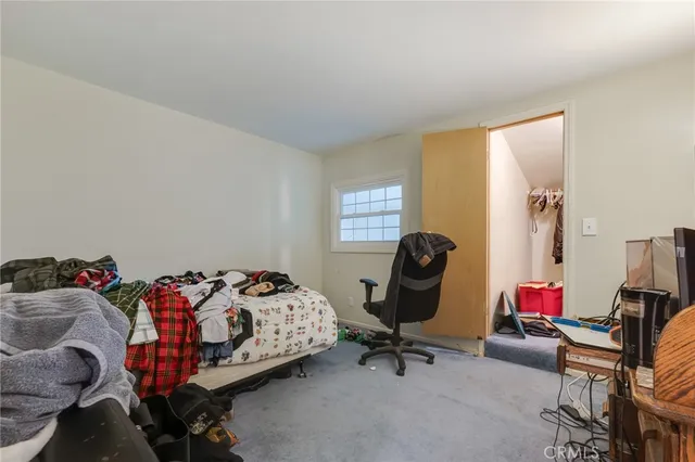 a bedroom with a bed and gym equipment