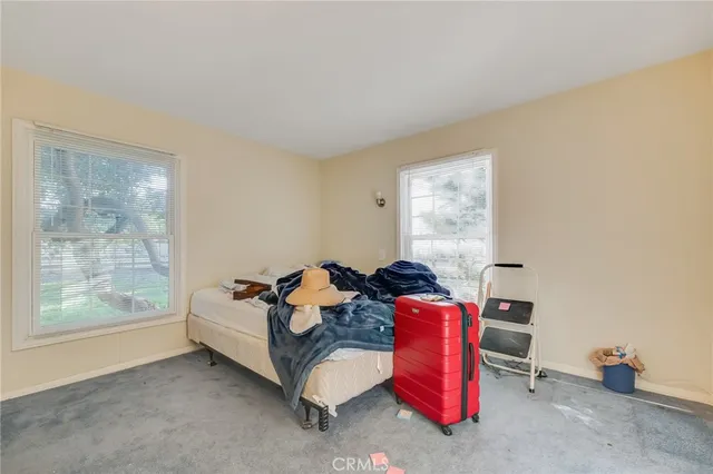 a bedroom with furniture and a window