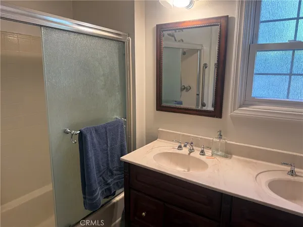 a bathroom with a sink vanity and mirror
