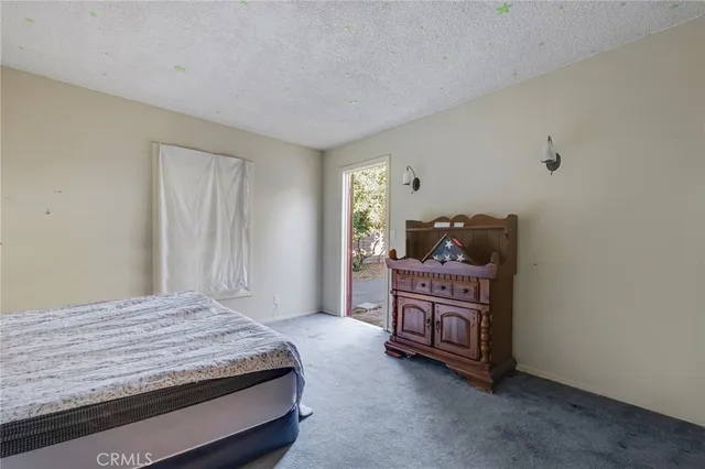 a bedroom with a bed and cabinets