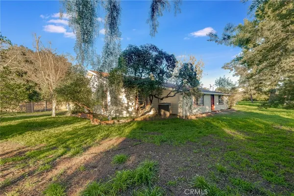 a view of a garden with a house in the background