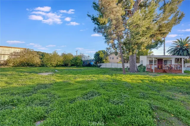 a view of a house with a yard and potted plants