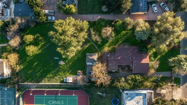 an aerial view of house with yard swimming pool and outdoor seating