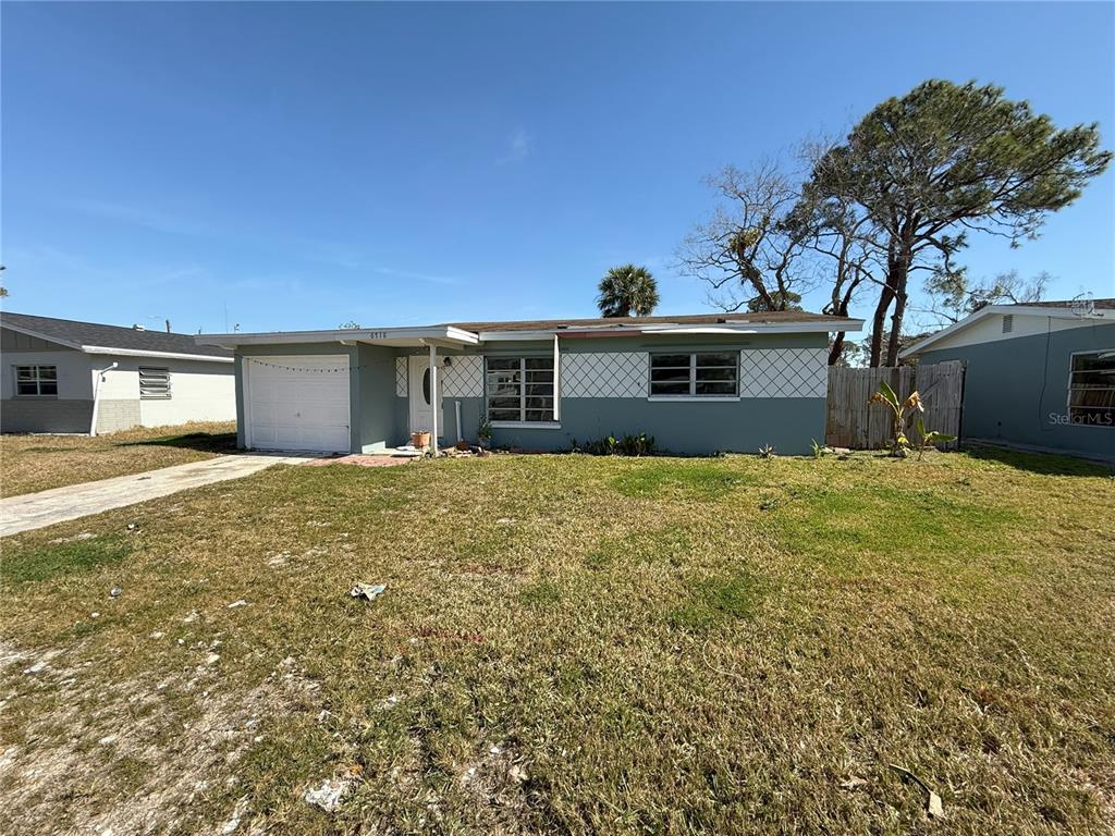 6718 Del Prado Terrace New Port Richey, FL 34652 - Photo 1 of 1 a front view of a house with a yard