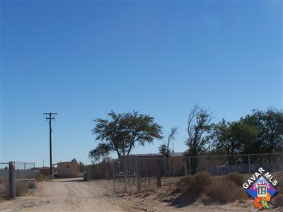 10116 Lone Butte Road Mojave, CA 93501 - Photo 1 of 5 a front view of a house with a yard and potted plants