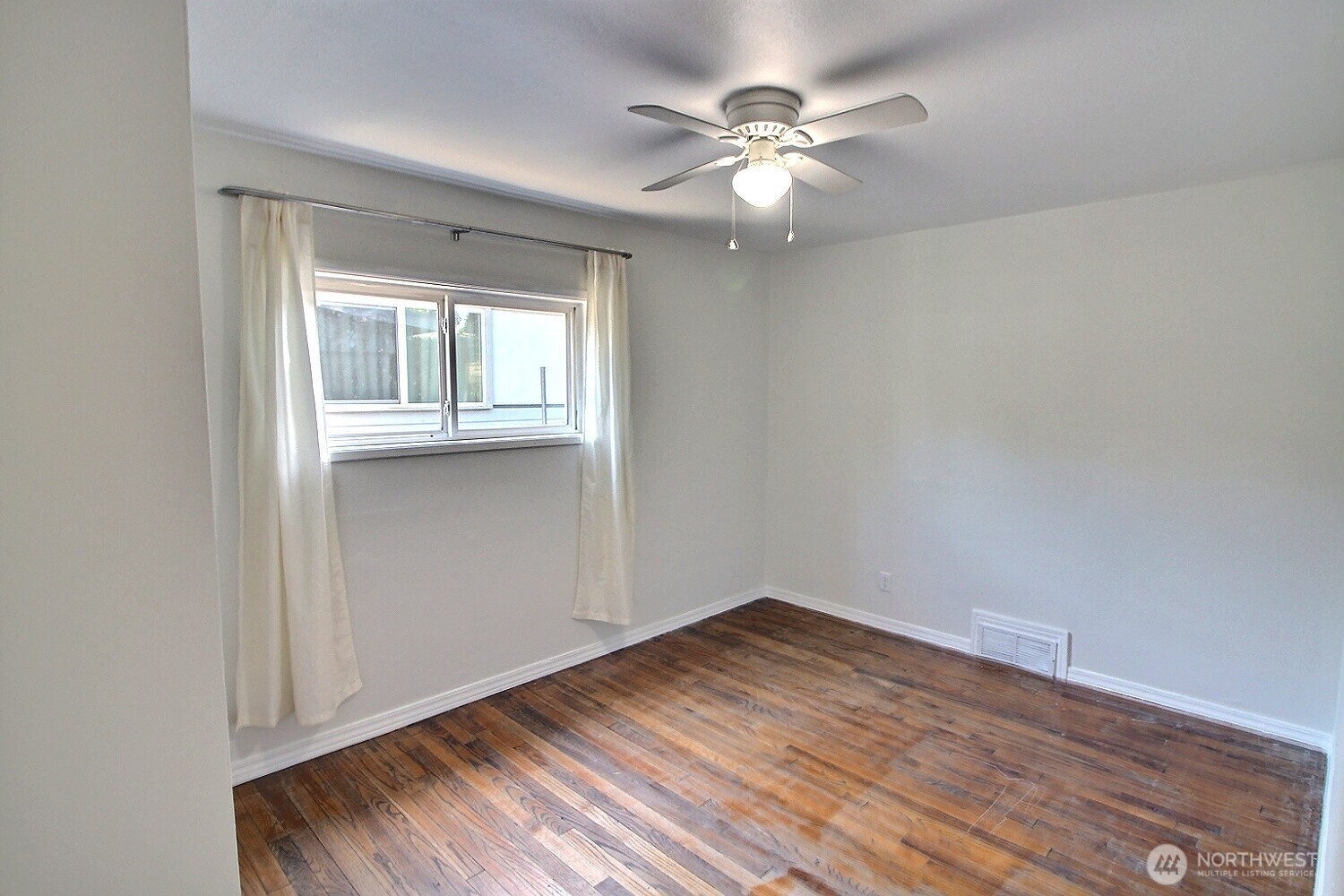 2309 Northeast 9th Place Renton, WA 98056 - Photo 11 of 38 wooden floor in an empty room with a window