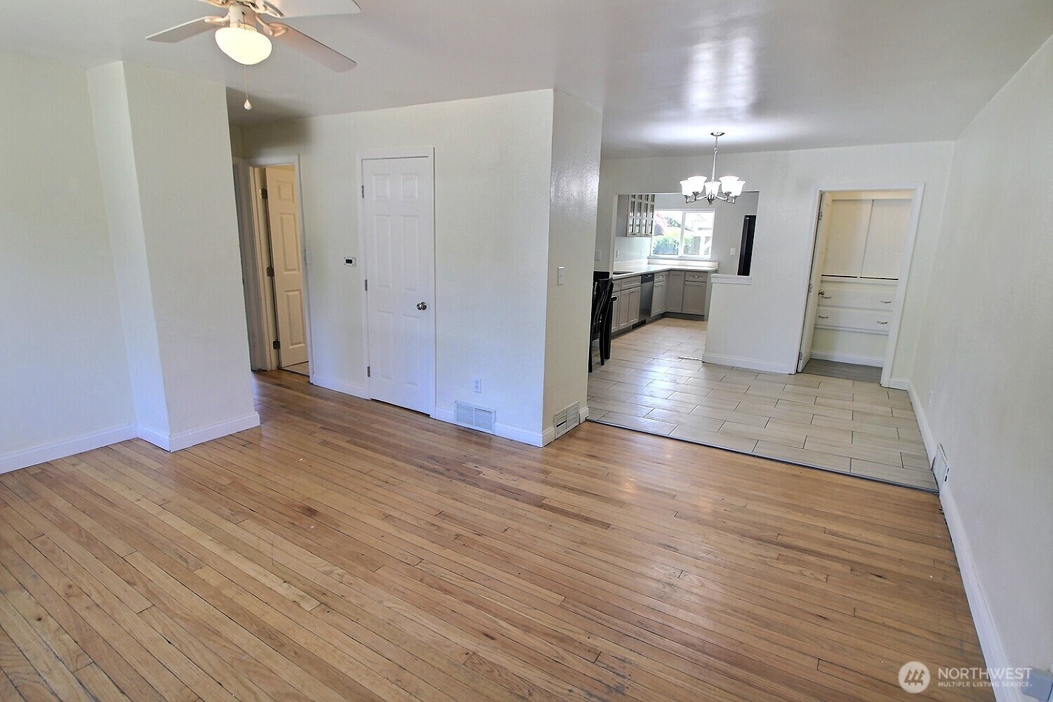 2309 Northeast 9th Place Renton, WA 98056 - Photo 2 of 38 a view of a room with wooden floor and a kitchen