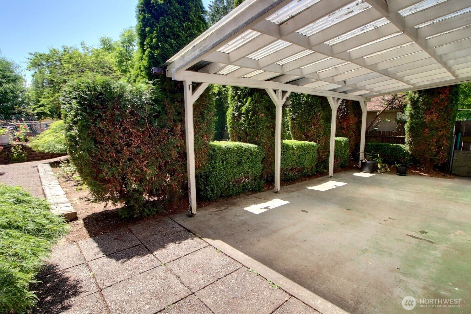 2309 Northeast 9th Place Renton, WA 98056 - Photo 27 of 38 a view of a patio with table and chairs under an umbrella with a large tree