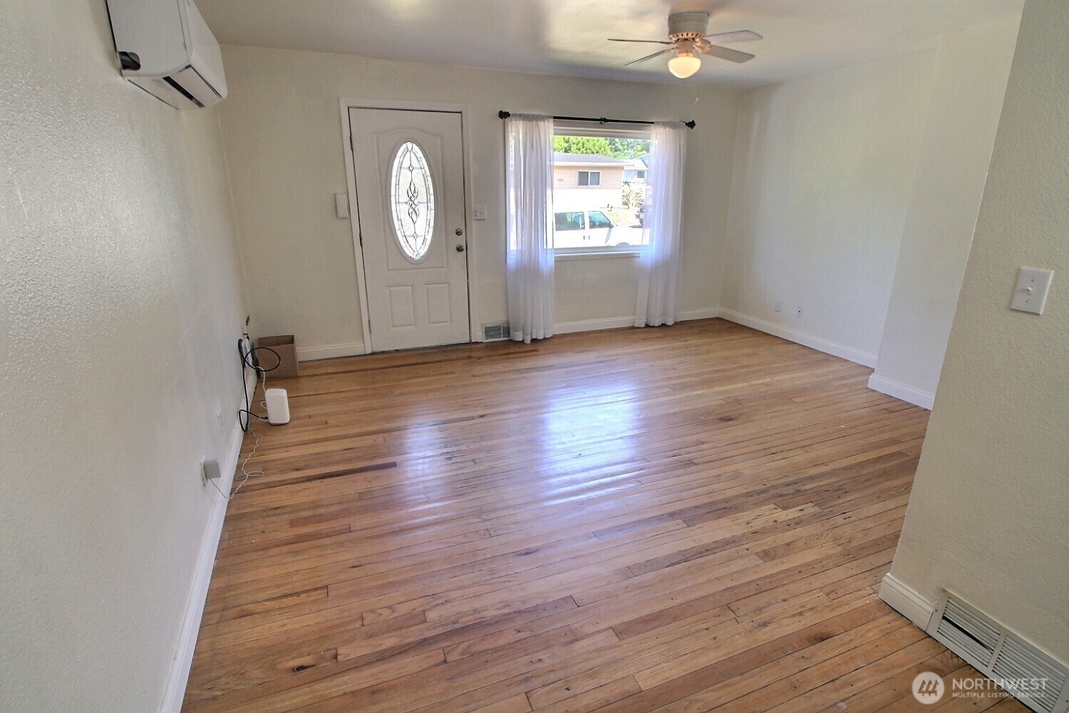 2309 Northeast 9th Place Renton, WA 98056 - Photo 3 of 38 an empty room with wooden floor and window