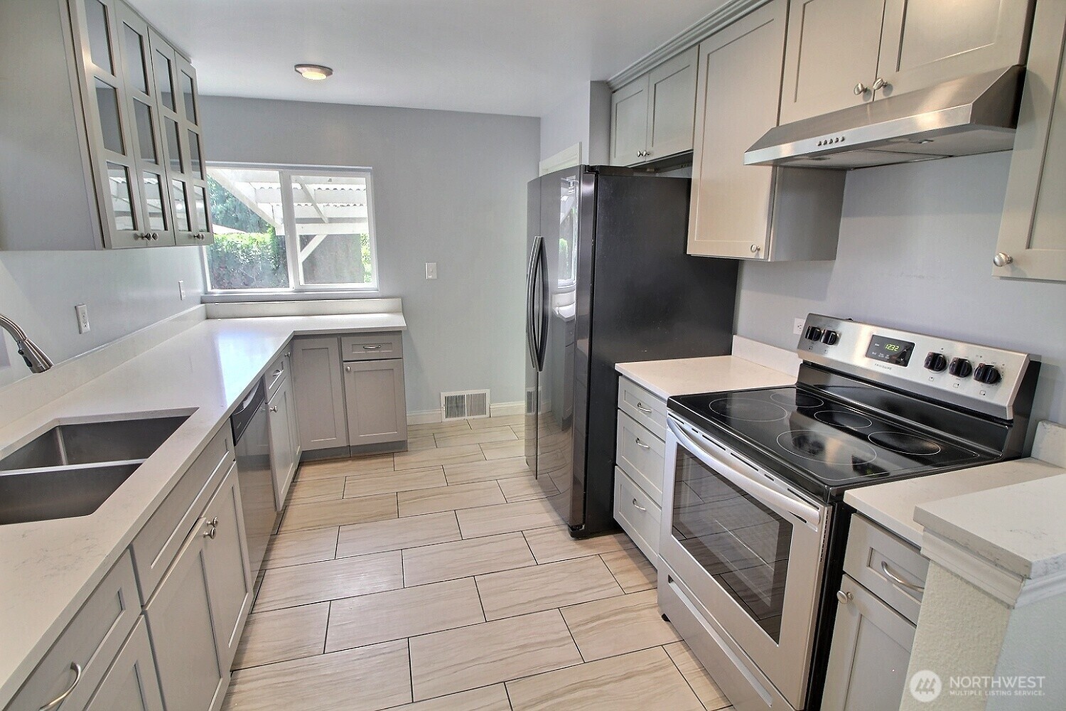 2309 Northeast 9th Place Renton, WA 98056 - Photo 5 of 38 a kitchen with stainless steel appliances granite countertop a stove a refrigerator and a sink