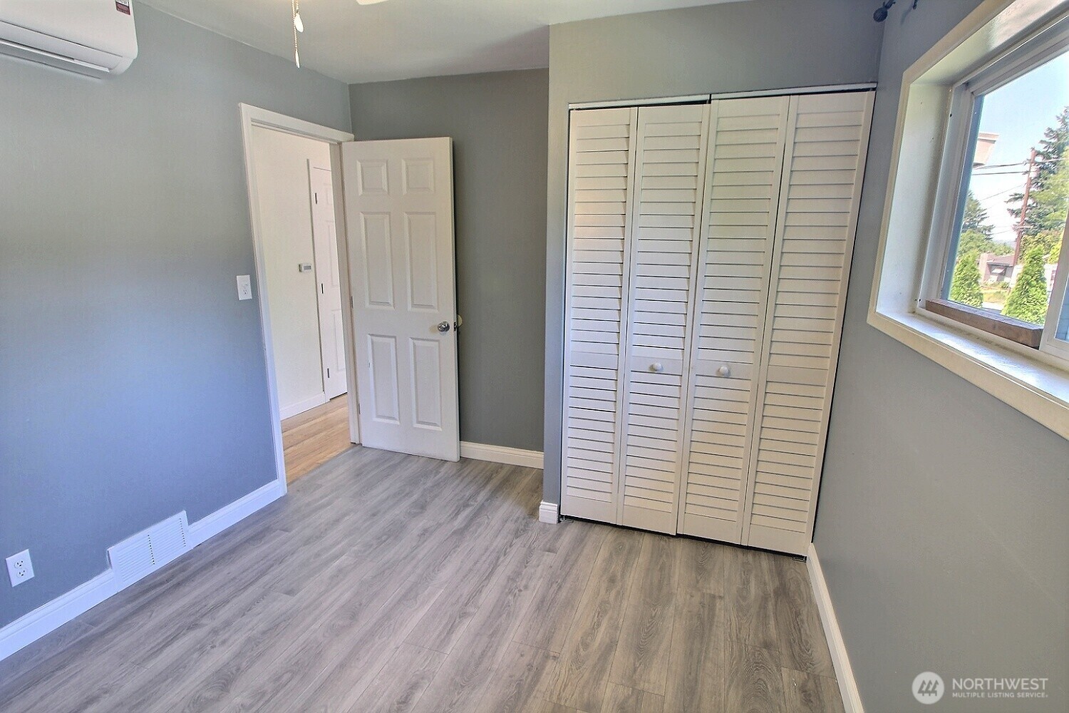 2309 Northeast 9th Place Renton, WA 98056 - Photo 10 of 38 an empty room with wooden floor and windows