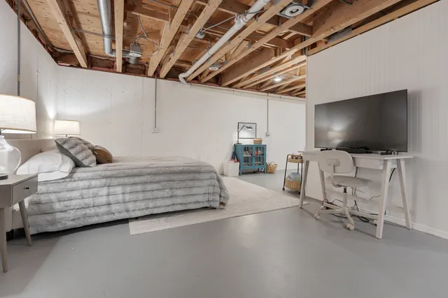 a bedroom with furniture and a flat screen tv