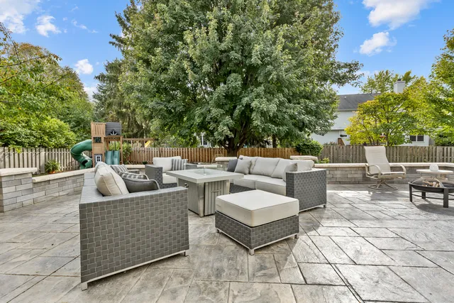 a roof deck with couches and potted plants