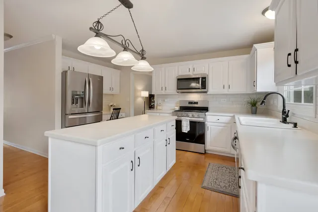 a kitchen with cabinets a sink and appliances