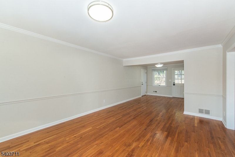 8 Abby Road Morristown, NJ 07960 - Photo 11 of 27 an empty room with wooden floor and windows