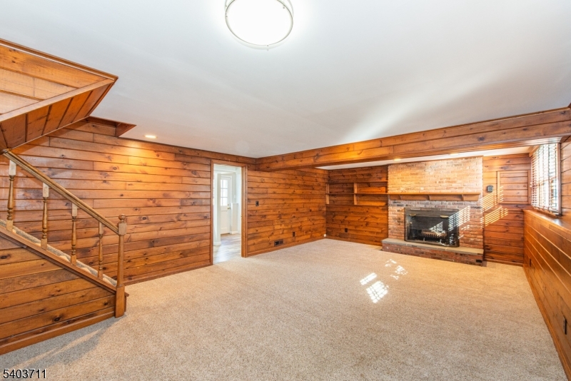 8 Abby Road Morristown, NJ 07960 - Photo 12 of 27 a view of an empty room with a fireplace and a large window