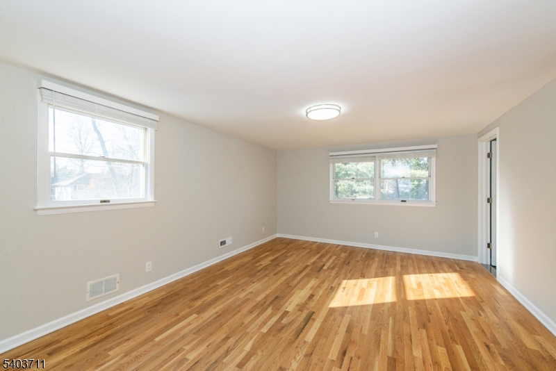 8 Abby Road Morristown, NJ 07960 - Photo 17 of 27 a view of empty room with wooden floor and fan
