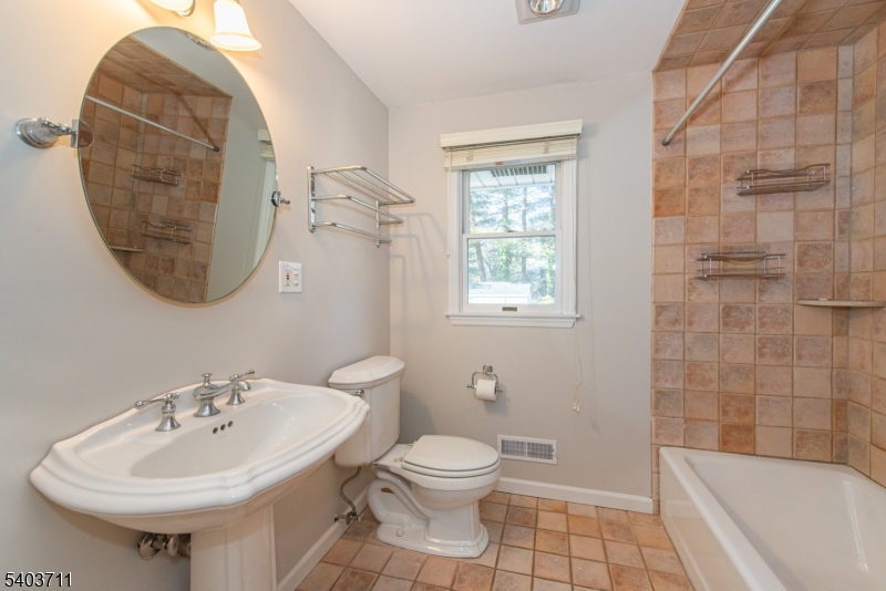 8 Abby Road Morristown, NJ 07960 - Photo 18 of 27 a bathroom with a sink a toilet and shower