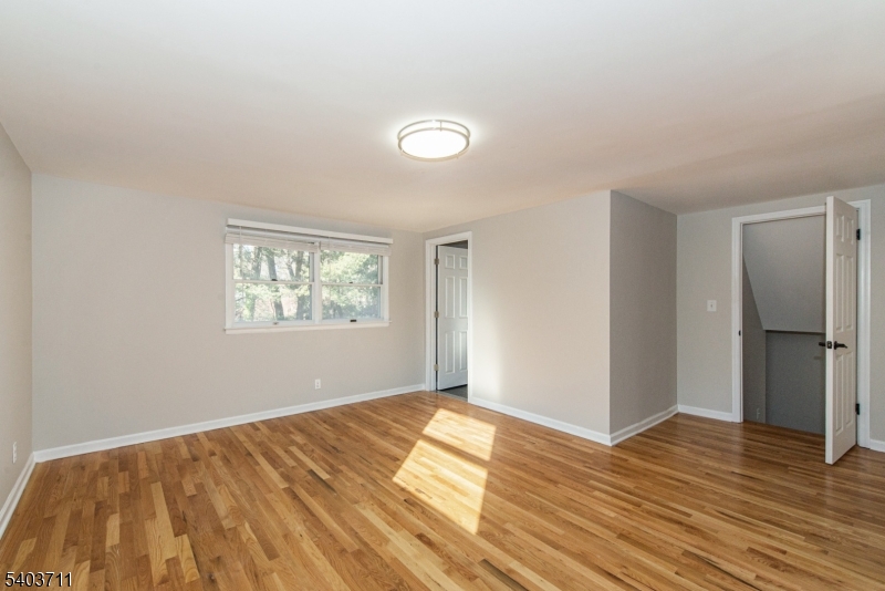 8 Abby Road Morristown, NJ 07960 - Photo 22 of 27 a view of empty room with wooden floor and fan
