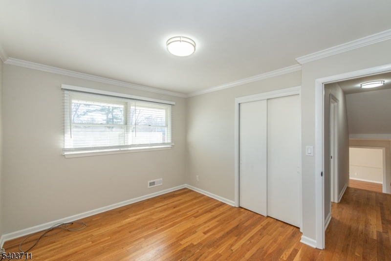 8 Abby Road Morristown, NJ 07960 - Photo 9 of 27 a view of empty room with wooden floor and fan